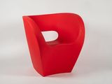 a red chair with a hole in the middle of it