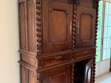 a large wooden cabinet in the middle of a room