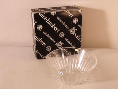 a glass bowl sitting on a table next to a box