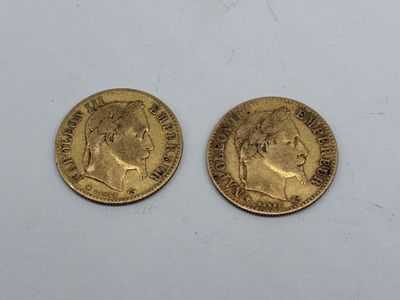two gold sovereigns, one with the head of a man and one with a woman