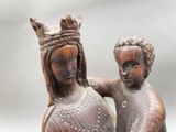 a statue of a woman holding a child on her lap