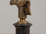 a statue of a man with a hat on top of a table