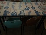 a table that has a bunch of chairs around it