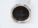 a silver pipe that is sitting on a white surface