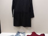 a black shirt, jeans, and a red shirt on a white table