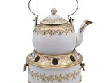 an image of a white tea kettle with gold trimmings and a black handle