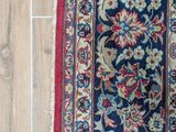 an image of a rug on a wooden floor with a cat laying on it