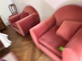 two chairs and a couch in a room with wood floors