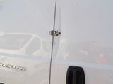 a white van that is parked on the side of the road