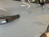 a close up of a car door handle with a sticker on it