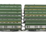 several green and white train cars sitting next to each other on a white surface