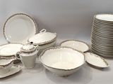 a lot of plates and bowls that are sitting on a table