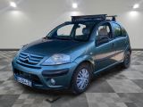 a picture of a small blue car parked in a garage