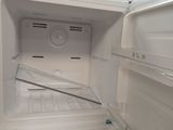 a white refrigerator with the door open in a room