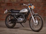 a motorcycle that is parked in front of a brick wall