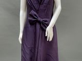 a mannequin wearing a purple dress with a large bow