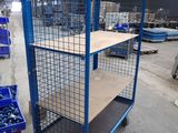 a blue cart with a shelf on it in a warehouse