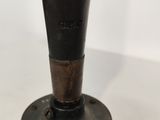 an old fashioned black and brown machine on a white surface