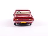 a red toy car that is sitting on a white surface