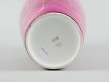 a pink vase with a white base and a pink bottom