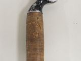 a hammer with a wooden handle on a white surface