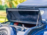 a blue car that is parked in the grass