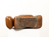 a wooden object that is on a white surface