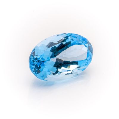 an oval blue topazte gems on a white background