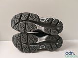 the soles of a pair of running shoes on a white surface
