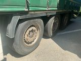 a green truck that is parked on the side of the road