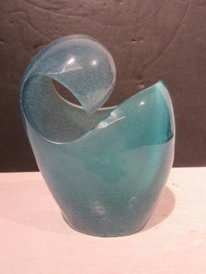 a blue glass vase sitting on a white table