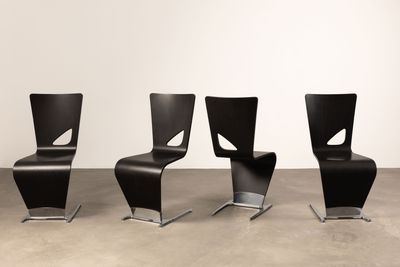 three black chairs sitting next to each other in a room