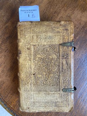 an old book sitting on top of a wooden table on a table