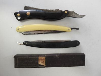 four different types of knives are displayed on a white surface