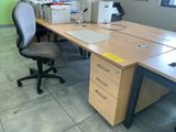 a desk with a chair and a computer on it