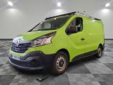 the green van is parked on a checkered tile floor