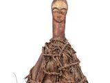 an image of a wooden figurine of a woman with a head made out of rope