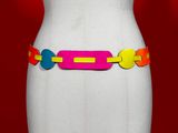 a white mannequin torso with a colorful belt on it