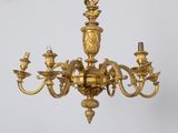 a gold colored chandelier hanging from the ceiling