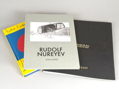 three books are stacked on top of each other on a table