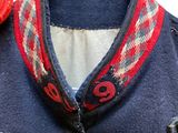an image of a jacket with a flower on it