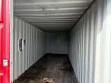 a red container sitting in the middle of a wooden floor