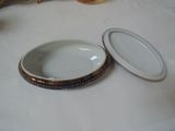 a white plate with a gold rim and a white plate with a gold rim