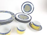 a lot of plates and cups that are sitting on a table