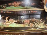 a wooden table with a painting on the top of it