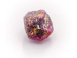 pink and purple rock on a white surface with a white background