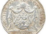 a close up of a coin on a white surface