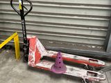 a skateboard that is sitting on the ground next to a fork
