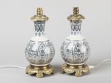 pair of white and gold table lamps with ornate designs on them