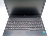 a laptop computer with a keyboard on a white surface